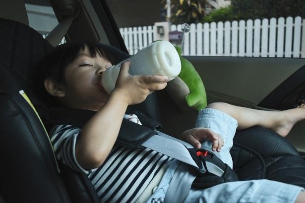 a child drinking milk in car