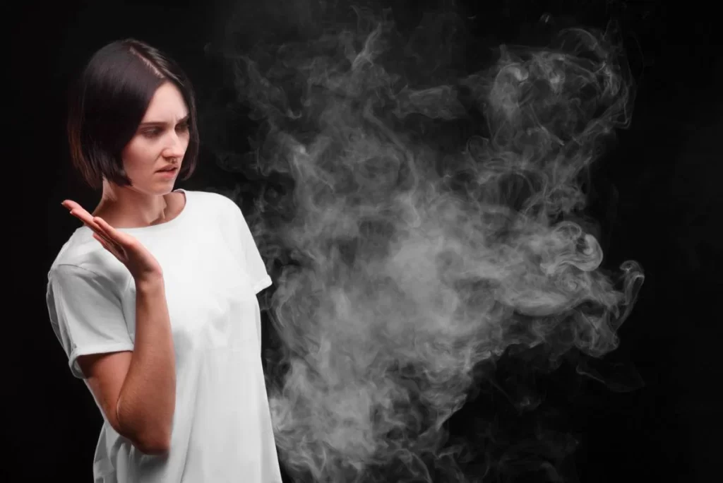 a girl is standing in smoke