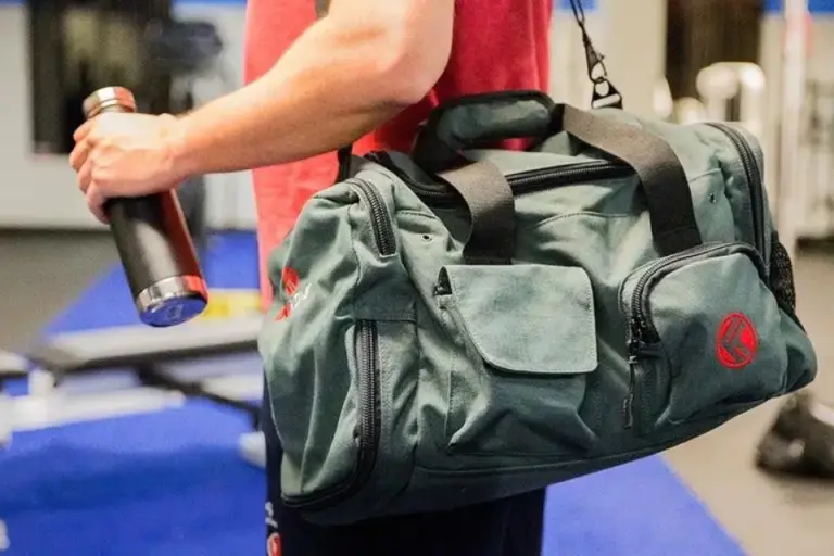 close shot of a man wearing gym bag.