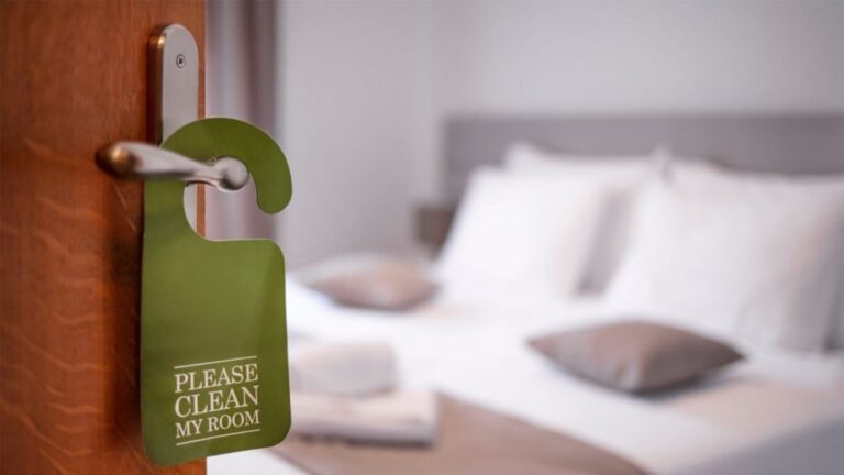 please clean my room tag hanging on a hotel room's door handle.